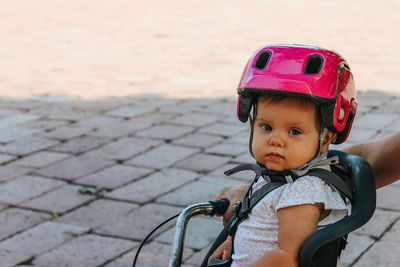 Portrait of boy with bicycle on footpath