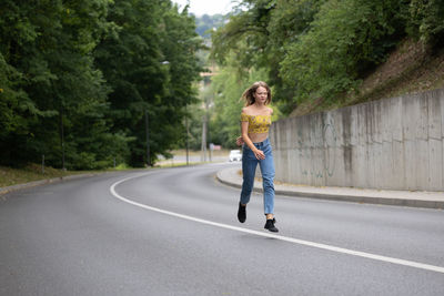 Full length of woman walking on road