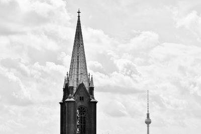 St mary church and fernsehturm against cloudy sky