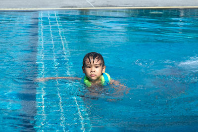 High angle view of boy swimming in pool