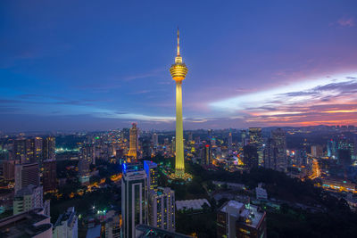 Illuminated cityscape against sky at night