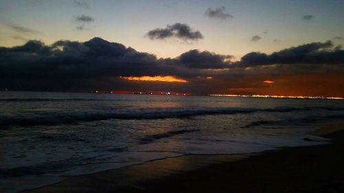 Scenic view of beach against sky during sunset