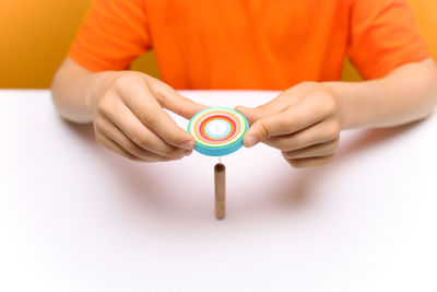 Midsection of man holding camera on table