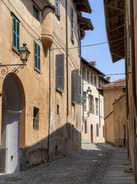 Street amidst buildings in town against sky