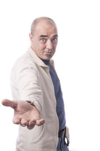 Portrait of man standing against white background