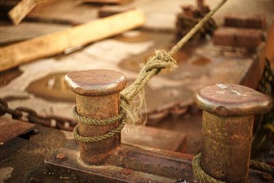 Close-up of rusty cleats at harbor