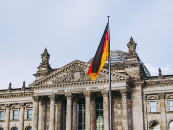 Low angle view of flags against sky