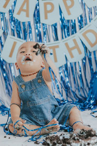 Portrait of young woman sitting at home