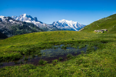 Scenic view of mountains against clear blue sky