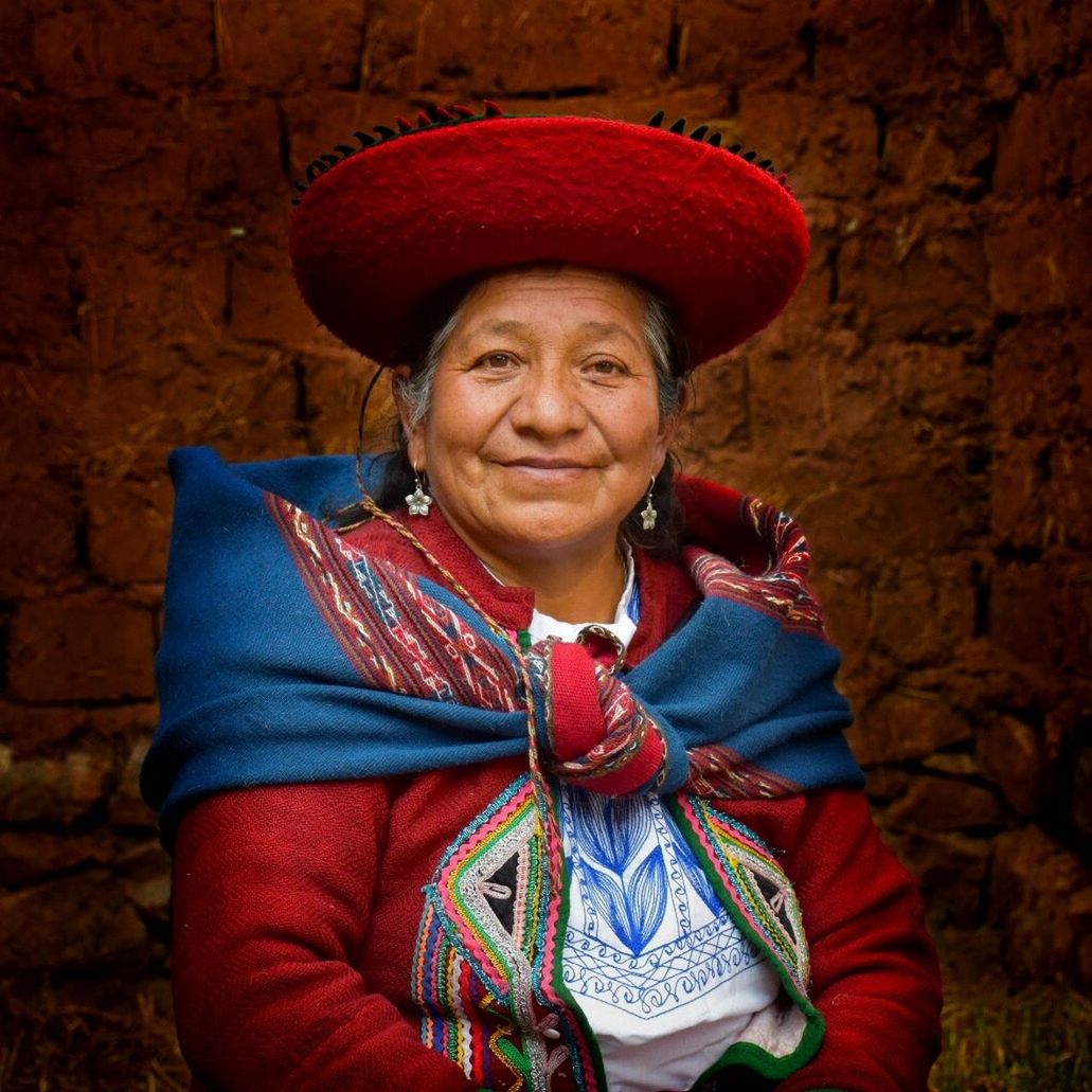 PORTRAIT OF A SMILING YOUNG WOMAN WITH RED HAT