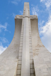 Low angle view of monument against cloudy sky