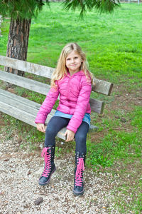 Portrait of young woman sitting on field