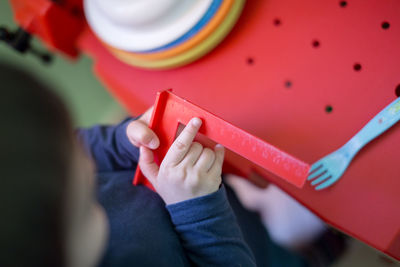 High angle view of boy playing with ruler at home