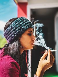 Portrait of woman smoking cigarette