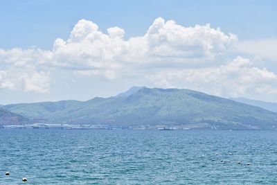 Scenic view of sea and mountains against sky