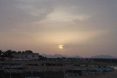 Buildings and sea against sky during sunset