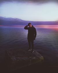 Full length of man standing on beach against sky