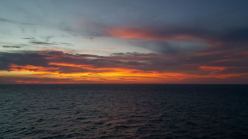 Scenic view of sea against romantic sky at sunset