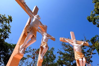 Low angle view of cross against clear blue sky