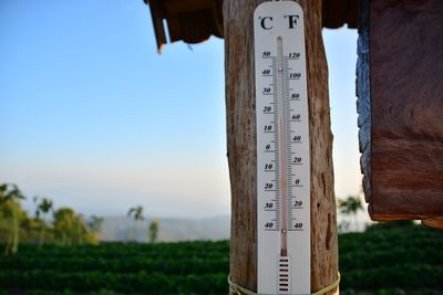 Close-up of wooden post against clear sky