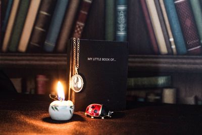 Close-up of lit candles on table