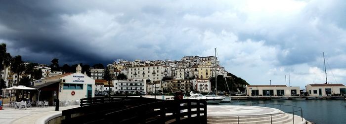 View of harbor against cloudy sky