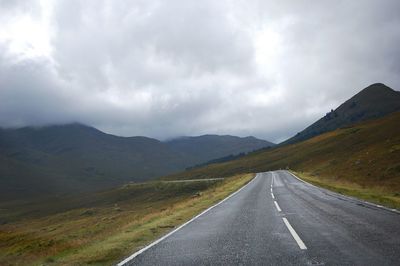 Empty road along countryside landscape