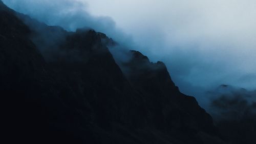 Low angle view of silhouette mountain against sky