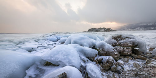 Scenic view of frozen sea against sky during winter
