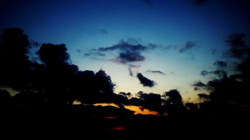 Low angle view of silhouette trees against sky at sunset