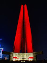 Low angle view of illuminated building against sky at night