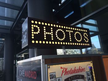 Low angle view of illuminated text on wall