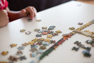 Close up of child putting puzzle together