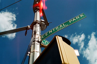 Low angle view of road sign against sky