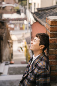 Portrait of man looking away in city