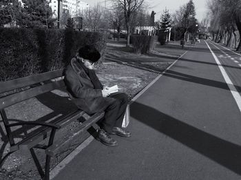 Boy sitting on bench