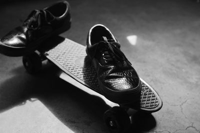 High angle view of shoes on skateboard at night