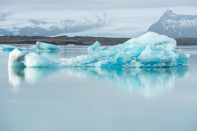 Frozen lake against sky during winter