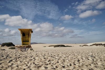 Lifeguard hut on beach against sky