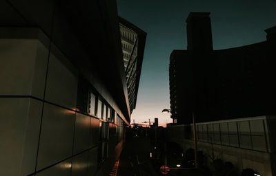 Low angle view of modern buildings against sky at sunset