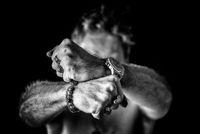 Close-up of man wearing jewelry and wristwatch