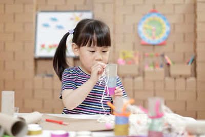 Girl looking at camera on table