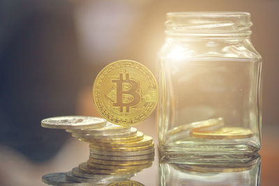 Close-up of coins in glass jar