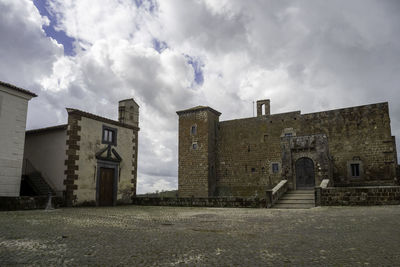 Buildings against cloudy sky