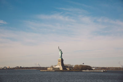 Statue in city at waterfront