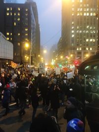 Crowd on street in city at night