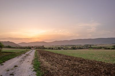 Scenic view of field against sky during sunset