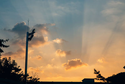 Low angle view of silhouette trees against sky during sunset