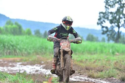 Man riding bicycle on field