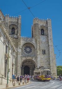 Group of people in historic building against sky